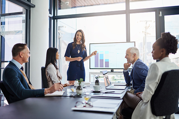 Woman presenting to her team in a meeting