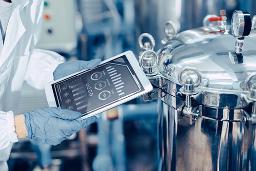 food production worker looking at data