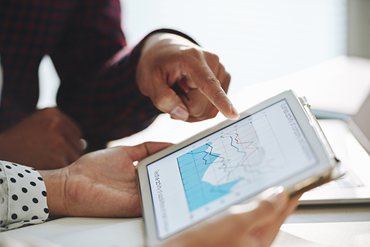 coworkers looking at a trends on tablet