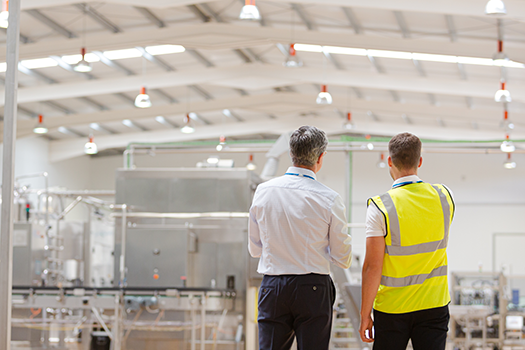 men in factory having a meeting