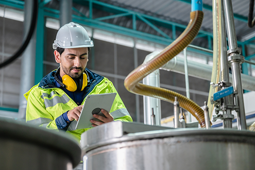 food safety worker inspecting machinery