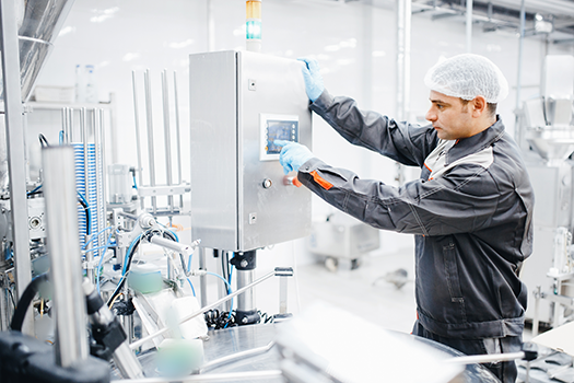 man performing maintenance on food plant machine