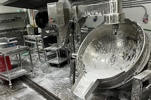 food production equipment being cleaned with soapy water